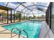 Enclosed pool showcasing clear blue water, surrounded by a patio for relaxation and leisure at 2368 Pellam Blvd, Port Charlotte, FL 33948
