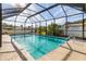 Inviting enclosed pool with clear blue water, surrounded by a screened enclosure for privacy at 2368 Pellam Blvd, Port Charlotte, FL 33948