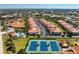 Community aerial view featuring residential buildings, a swimming pool, and tennis courts at 240 West End Dr # 622, Punta Gorda, FL 33950