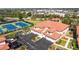 Aerial shot of a community with townhomes, tennis courts, parking, and lush greenery under a sunny sky at 240 West End Dr # 622, Punta Gorda, FL 33950
