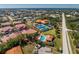 Aerial view shows community with tennis courts, pool, and proximity to the bay and a nearby commercial area at 240 West End Dr # 622, Punta Gorda, FL 33950