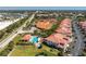 Aerial view showcases community buildings, a pool, and tennis courts at 240 West End Dr # 622, Punta Gorda, FL 33950
