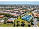 Community aerial view highlighting multiple residential buildings, swimming pool, and tennis courts at 240 West End Dr # 622, Punta Gorda, FL 33950