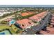 Aerial view of the community featuring residential buildings, a pool, and tennis courts at 240 West End Dr # 622, Punta Gorda, FL 33950