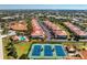 Community aerial view featuring residential buildings, a swimming pool, and tennis courts at 240 West End Dr # 622, Punta Gorda, FL 33950