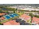 Community aerial view of townhomes, parking, tennis courts and surrounding commercial areas and roads at 240 West End Dr # 622, Punta Gorda, FL 33950