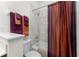 Cozy bathroom featuring tile surround, shower and tub combo, and a matching orange and purple curtain and towel set at 240 West End Dr # 622, Punta Gorda, FL 33950