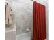Bathroom featuring tile surround, shower and tub combo, and a red curtain at 240 West End Dr # 622, Punta Gorda, FL 33950