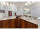 Bathroom featuring double sinks, vanity, marble countertop, and vanity with many cabinets for storage at 240 West End Dr # 622, Punta Gorda, FL 33950