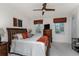Bright bedroom features carpet floors, a ceiling fan, and a wooden bed frame at 240 West End Dr # 622, Punta Gorda, FL 33950