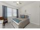 Bedroom with cozy chair, ceiling fan, and stylish blue accents at 240 West End Dr # 622, Punta Gorda, FL 33950