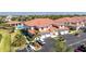 Exterior view of community building with garages, palm trees, and manicured landscaping at 240 West End Dr # 622, Punta Gorda, FL 33950