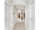 Hallway featuring tile floors, arched doorways, and views of the kitchen and dining area at 240 West End Dr # 622, Punta Gorda, FL 33950