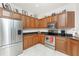 Well-lit kitchen featuring stainless steel appliances, granite countertops, and wood cabinetry at 240 West End Dr # 622, Punta Gorda, FL 33950