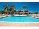 Community pool with lounge chairs and red tile roofed building at 240 West End Dr # 622, Punta Gorda, FL 33950