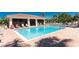 Outdoor pool with lounge chairs, tropical landscaping and a nearby building with covered seating area at 240 West End Dr # 622, Punta Gorda, FL 33950