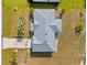 Aerial view shows a well-maintained roof, driveway, mature trees and surrounding landscape at 25313 Durango Ct, Punta Gorda, FL 33955