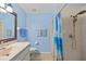 The light blue bathroom has a shower, a vanity with a sink, and a toilet at 25313 Durango Ct, Punta Gorda, FL 33955
