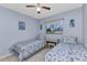Inviting bedroom with twin beds, neutral colors, and window at 2679 Pascal Ave, North Port, FL 34286