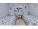 Inviting bedroom with twin beds, neutral colors, and window at 2679 Pascal Ave, North Port, FL 34286