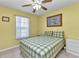 Comfortable bedroom featuring a queen-sized bed, ceiling fan, and window at 2679 Pascal Ave, North Port, FL 34286