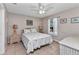 Comfortable bedroom with a ceiling fan, bright window, and neutral decor, offering a cozy retreat at 2679 Pascal Ave, North Port, FL 34286