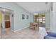 Bright dining area features a wooden table and chairs, tile floors, and sliding glass doors leading to the exterior at 2679 Pascal Ave, North Port, FL 34286