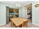 Bright dining room featuring a wooden table, tile flooring, and sliding glass doors to the patio at 2679 Pascal Ave, North Port, FL 34286