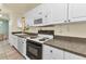 Functional kitchen featuring white appliances and cabinets, offering a practical space for meal preparation at 2679 Pascal Ave, North Port, FL 34286