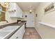 Practical kitchen featuring white cabinets, a double sink, and tile flooring, perfect for everyday living at 2679 Pascal Ave, North Port, FL 34286
