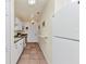 Functional kitchen featuring white appliances, ample cabinetry, and tile flooring for easy maintenance at 2679 Pascal Ave, North Port, FL 34286