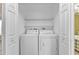 Convenient laundry closet featuring a stacked washer and dryer unit, maximizing space and functionality at 2679 Pascal Ave, North Port, FL 34286
