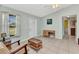 Bright living room with light blue walls, tile flooring, ceiling fan and a glass paneled front door at 2679 Pascal Ave, North Port, FL 34286