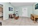 Cozy living room with light blue walls, tile flooring, and natural light coming through window and front door at 2679 Pascal Ave, North Port, FL 34286