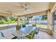 Enclosed patio with ample seating, ceiling fans, and views of the backyard at 2679 Pascal Ave, North Port, FL 34286