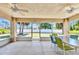Enclosed patio with ample seating, ceiling fans, and views of the backyard at 2679 Pascal Ave, North Port, FL 34286