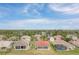 Aerial view of a neighborhood showcasing well-maintained homes, landscaping, and surrounding greenery at 2699 Suncoast Lakes Blvd, Punta Gorda, FL 33980