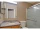 Bright bathroom featuring a granite countertop single sink vanity and a glass-enclosed shower for easy cleaning at 2699 Suncoast Lakes Blvd, Punta Gorda, FL 33980