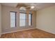 A bright and airy bedroom featuring beautiful wood floors, large windows, and an arched transom at 2699 Suncoast Lakes Blvd, Punta Gorda, FL 33980