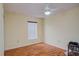 Cozy bedroom showcasing beautiful wood floors and a window with privacy blinds, creating a peaceful atmosphere at 2699 Suncoast Lakes Blvd, Punta Gorda, FL 33980