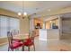 The dining area features a charming table set with red cushioned chairs near the kitchen, bathed in natural light at 2699 Suncoast Lakes Blvd, Punta Gorda, FL 33980