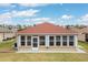 View of the sunroom featuring a wall of windows, access door, and serene outdoor space at 2699 Suncoast Lakes Blvd, Punta Gorda, FL 33980