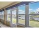 Bright sunroom featuring tile flooring, large windows, and scenic water views that offer tranquility at 2699 Suncoast Lakes Blvd, Punta Gorda, FL 33980