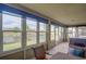 Bright sunroom featuring tile flooring, large windows, and scenic water views that offer tranquility at 2699 Suncoast Lakes Blvd, Punta Gorda, FL 33980