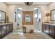 Luxurious bathroom with dual vanities, decorative mirror and two walk-in showers at 2850 Magdalina Dr, Punta Gorda, FL 33950