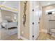 Bright bedroom entryway leading to en-suite bathroom with luxurious finishes at 2850 Magdalina Dr, Punta Gorda, FL 33950