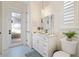 Bathroom with white vanity, shutters, and door to outside at 2850 Magdalina Dr, Punta Gorda, FL 33950
