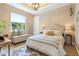 Cozy bedroom features an upholstered bed frame, storage bench and ceiling light fixture at 2850 Magdalina Dr, Punta Gorda, FL 33950