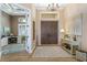 Elegant foyer with high ceilings, double doors, decorative chandelier, and a view into a bright office space at 2850 Magdalina Dr, Punta Gorda, FL 33950