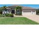 Charming single-story home with a paver driveway, mature landscaping, and a three-car garage at 2850 Magdalina Dr, Punta Gorda, FL 33950